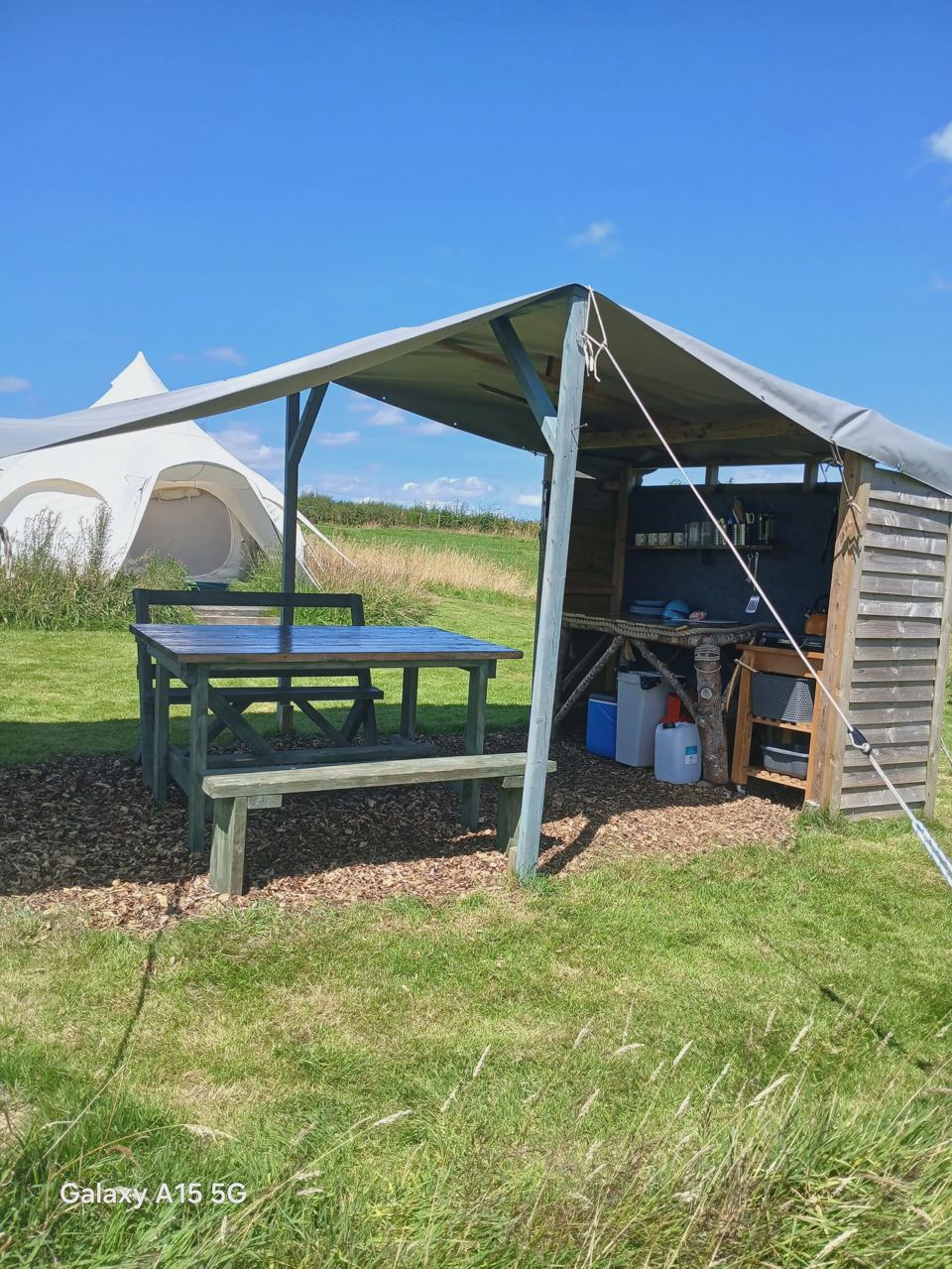 Bell tent and shelter with picnic table