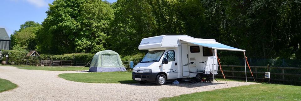 Motorhome and tent on gravel