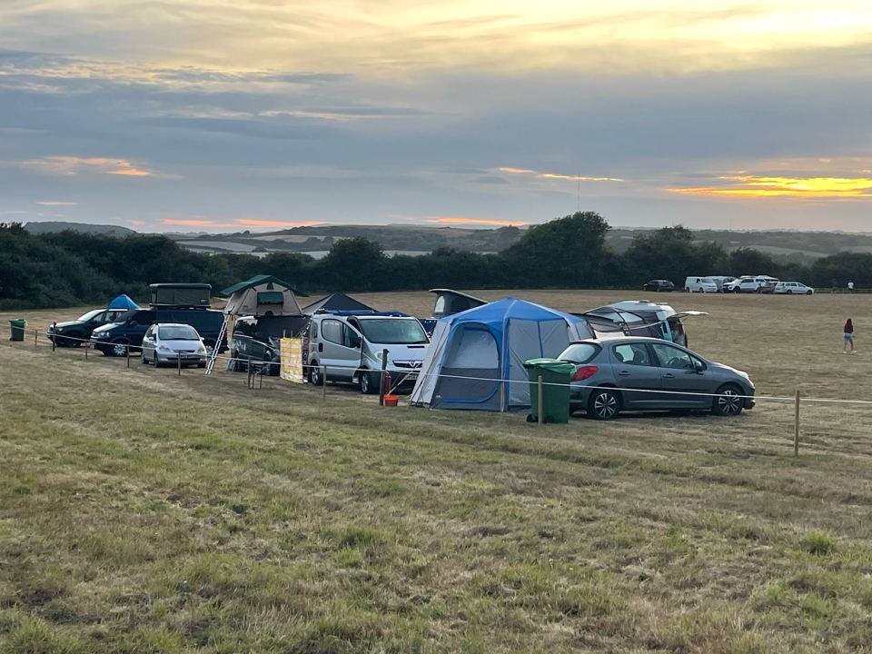 Campers in the meadow at dusk