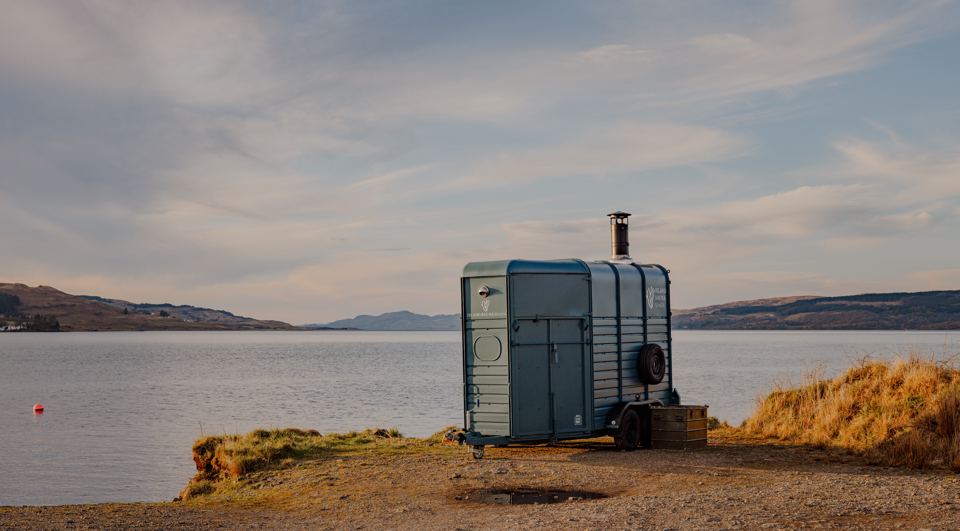 Wood-fired sauna trailer on the shore