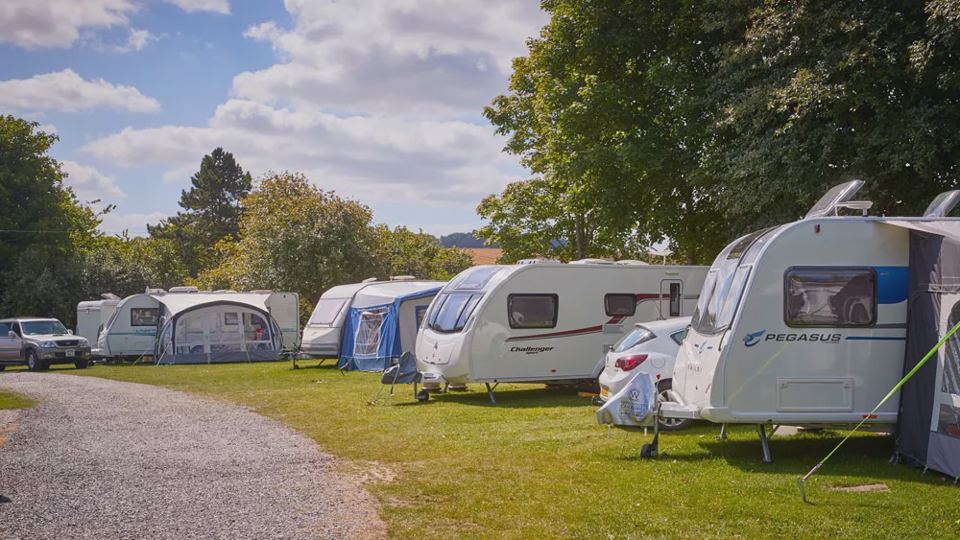 Caravans with awnings on grass