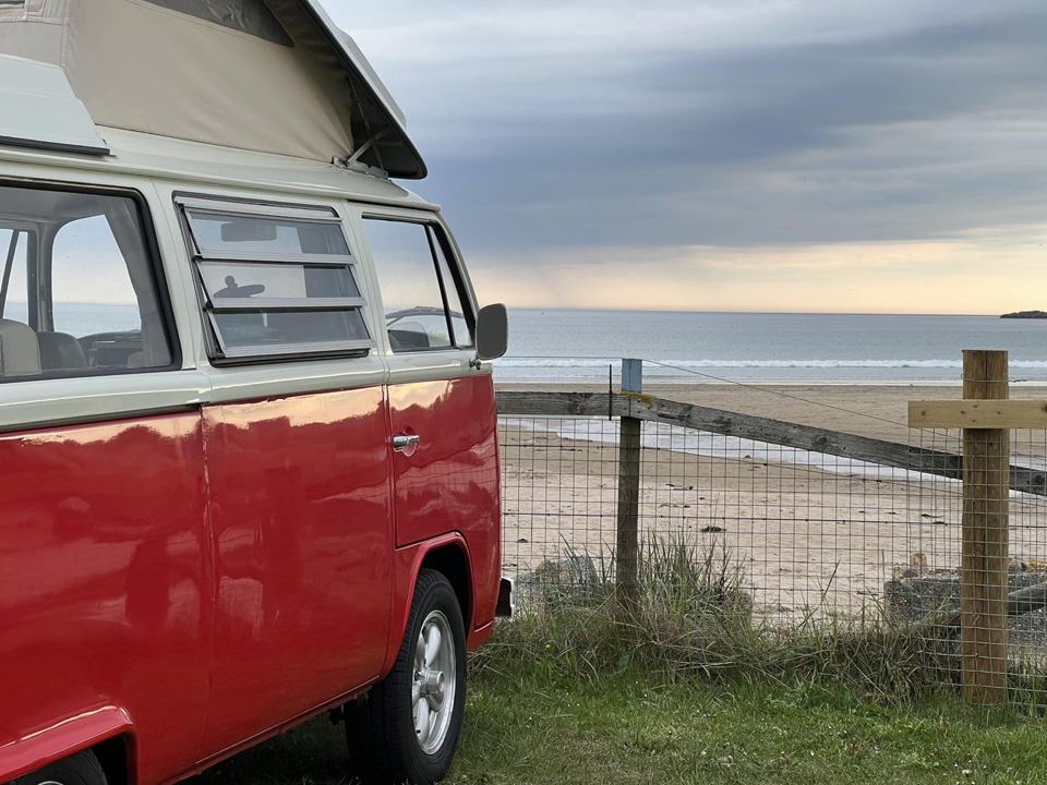 Campervan beside the beach fence