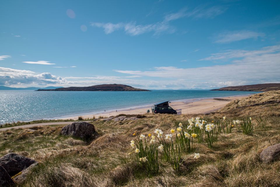 Sandy bay with a campervan
