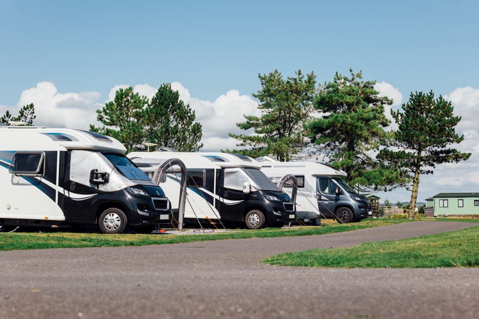 Row of motorhomes on gravel pitches