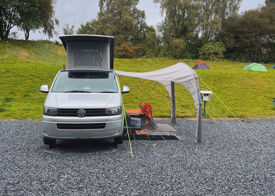 Campervan with awning on gravel