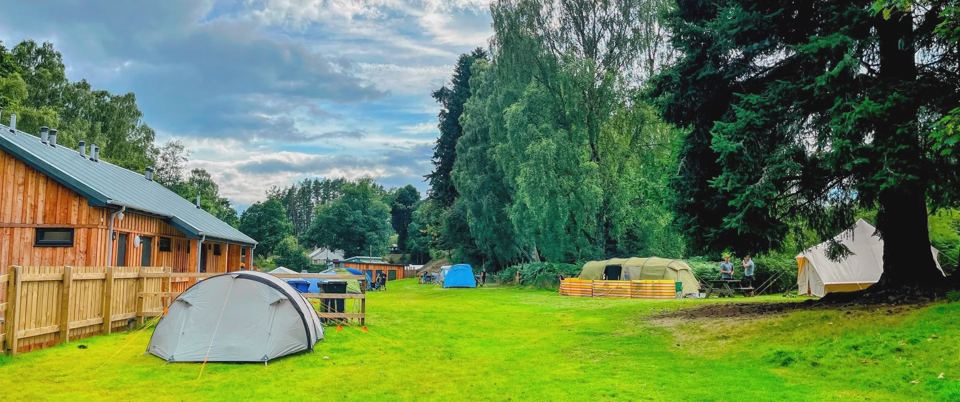 Tent field and timber building
