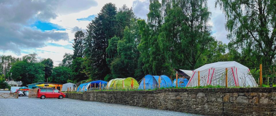 Row of tents by the stone wall