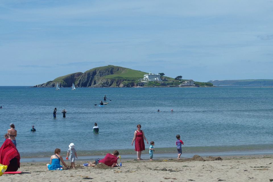 Beach with people paddling