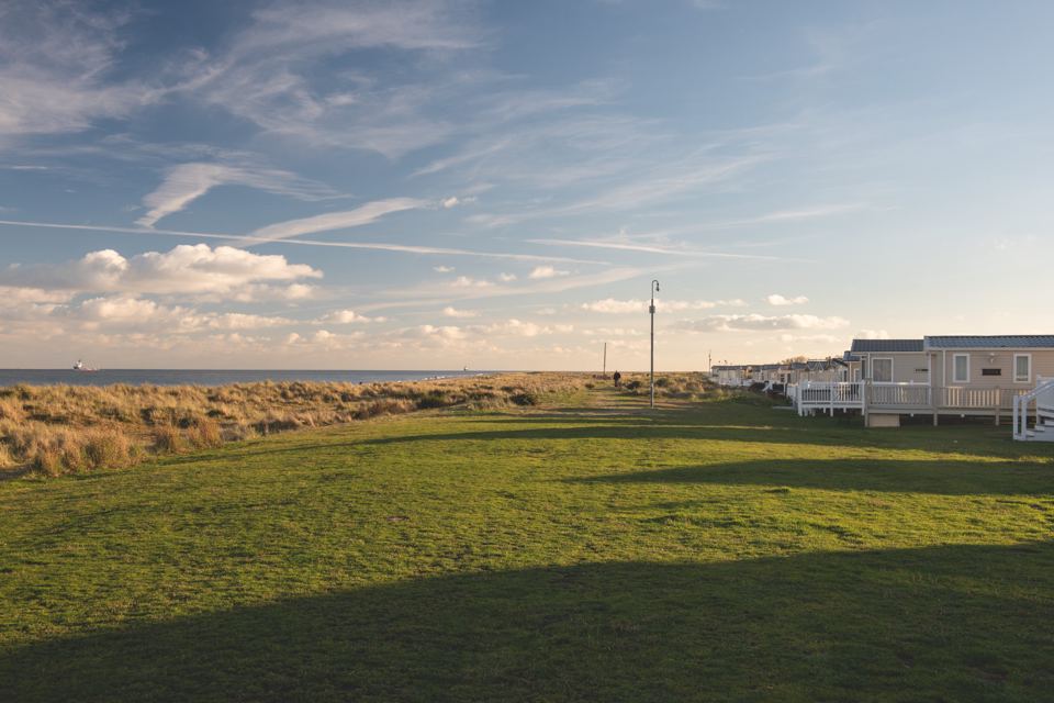 Grass and dunes beside the caravans
