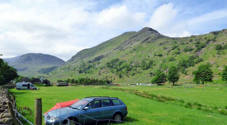 Car and tent in the valley field