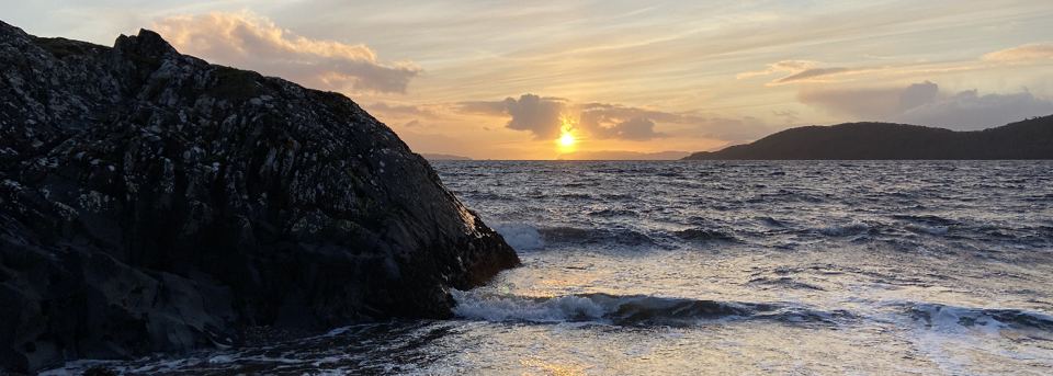 Sunset over rocks and sea