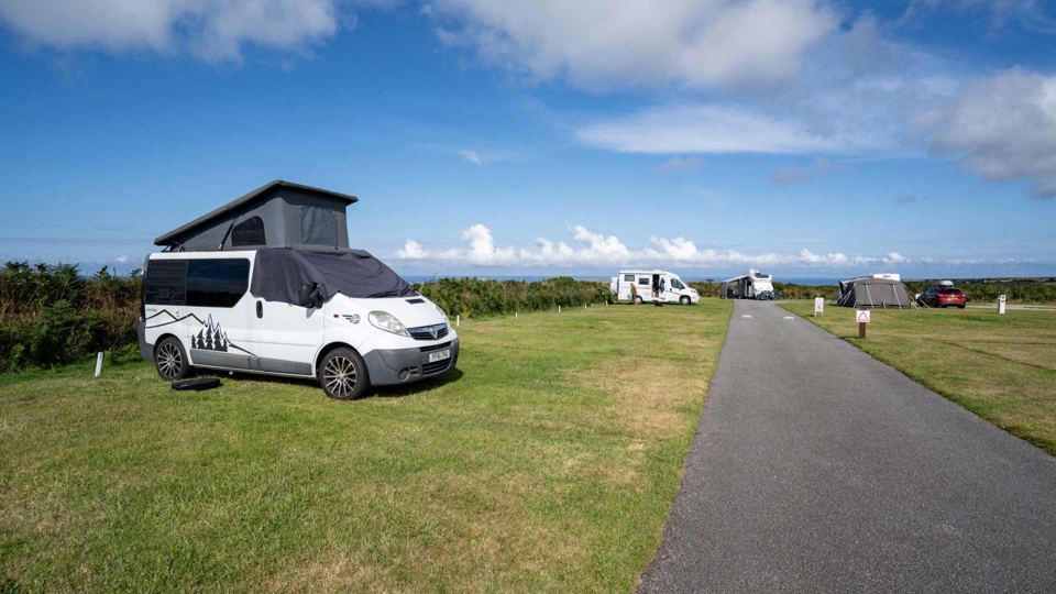 Campervan on the grass pitches by the sea