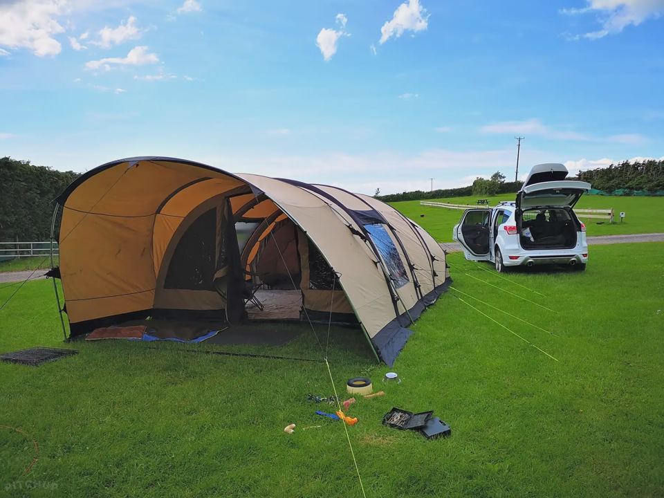 Large tent beside the car on the grass