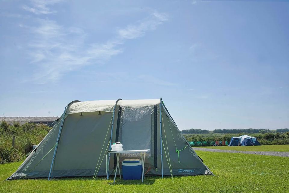 Green tent on the grass pitch