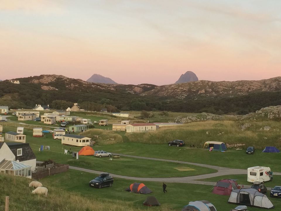 Pitches and caravans below the hills