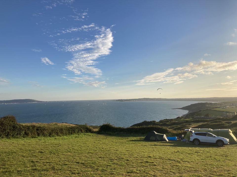 Field and tents above the bay