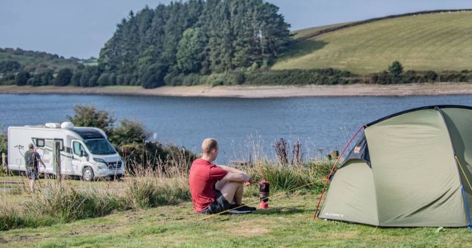 Tent and motorhome by the lake