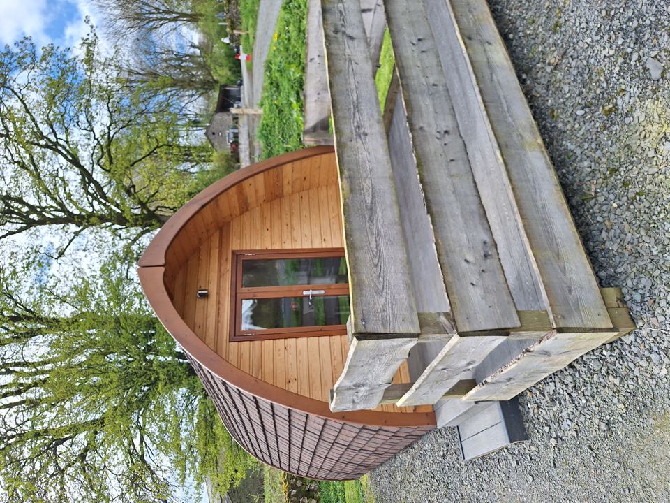 Wooden hot tub on gravel
