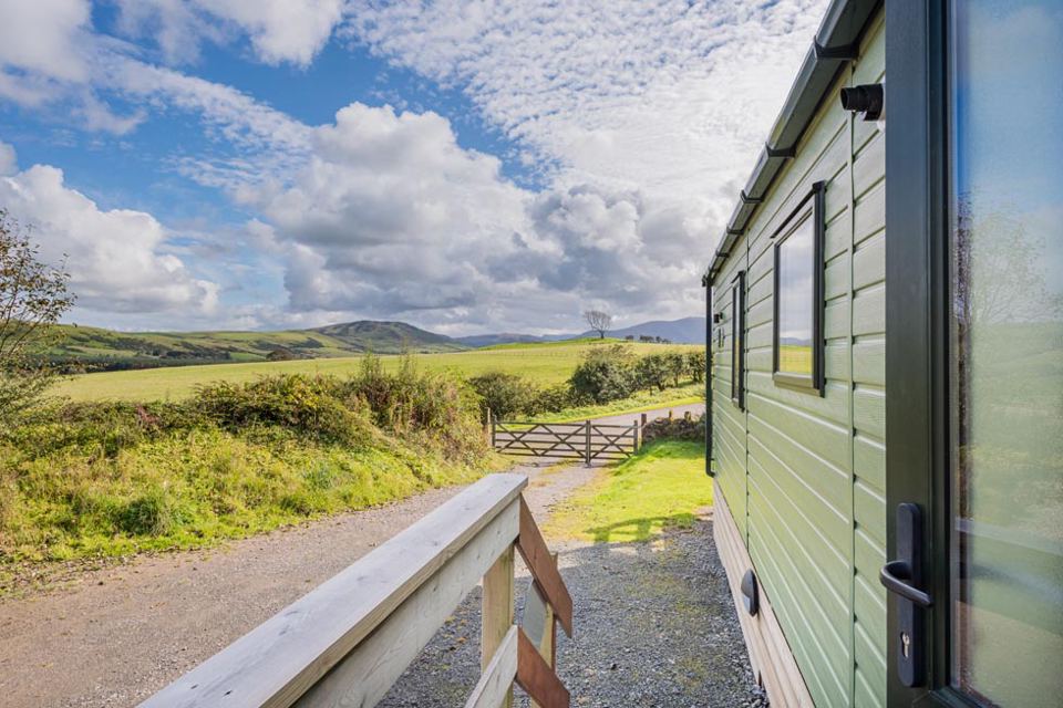 Static caravan with hills beyond