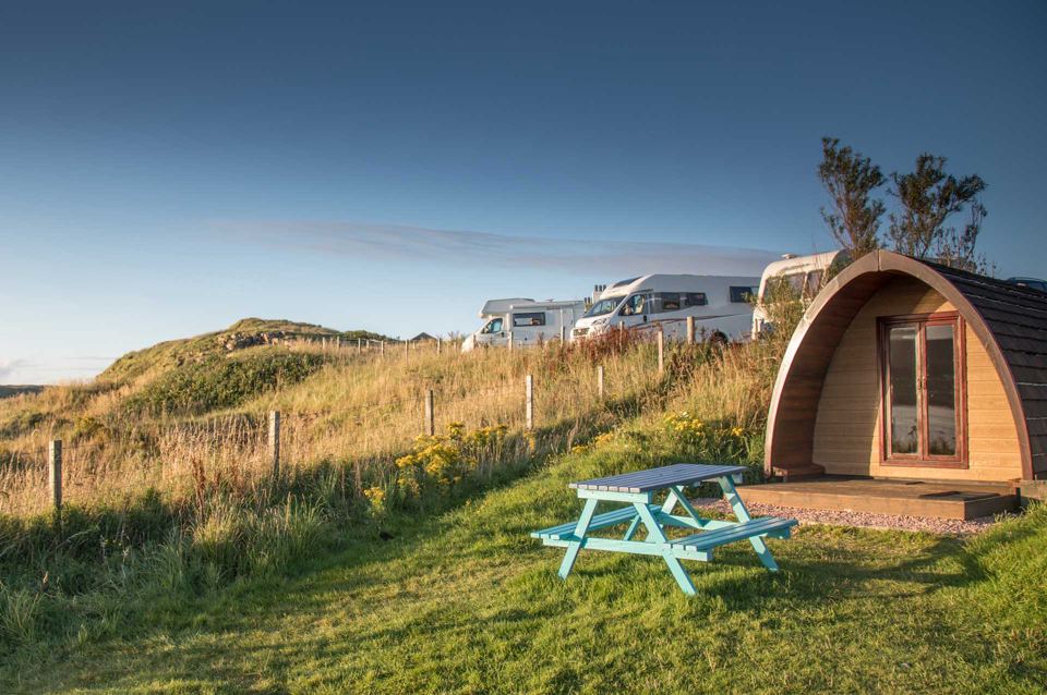 Camping pod with vans behind