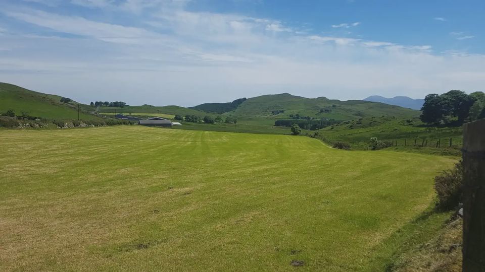 Grass camping field with hill views