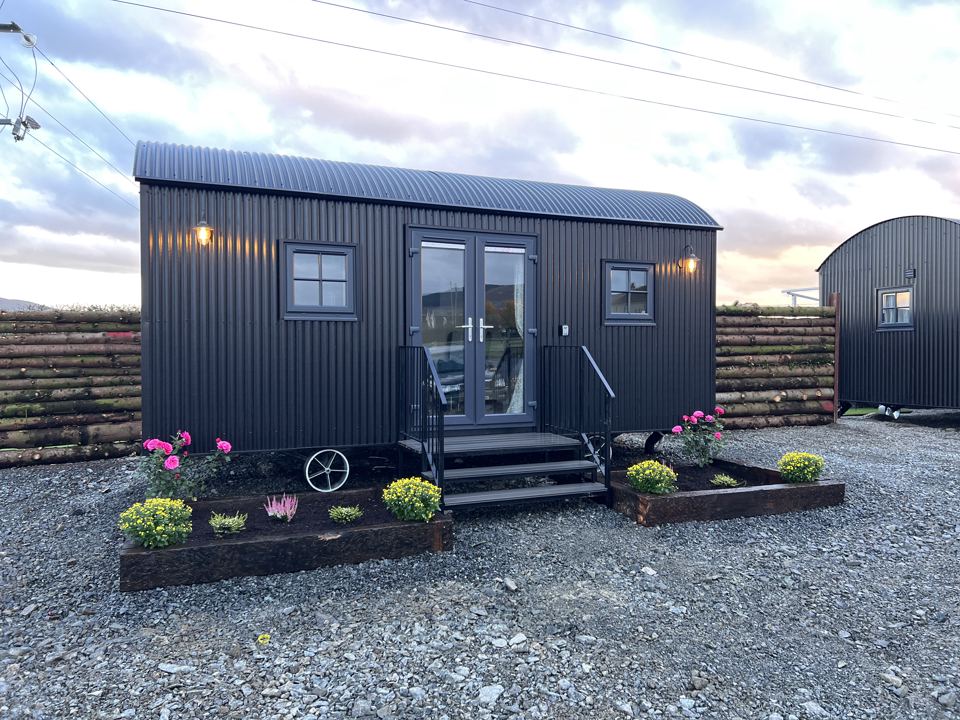 Dark hut with flower beds