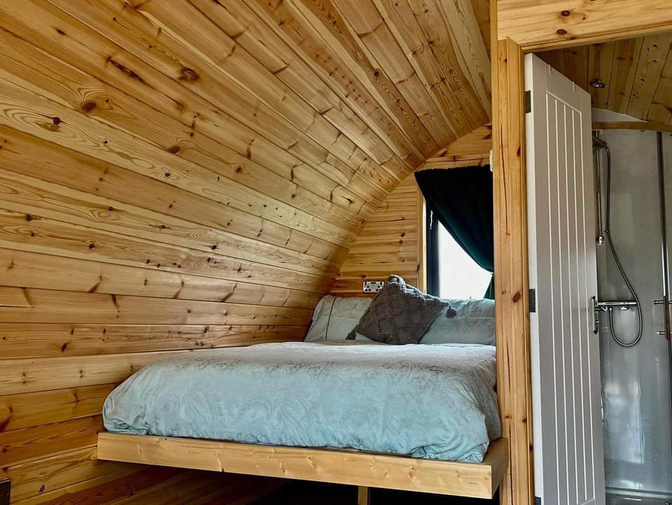 Double bed and shower in pod