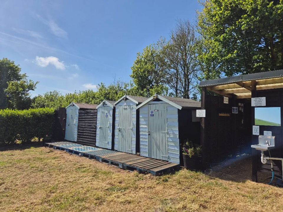 Wooden toilet block by the beach huts