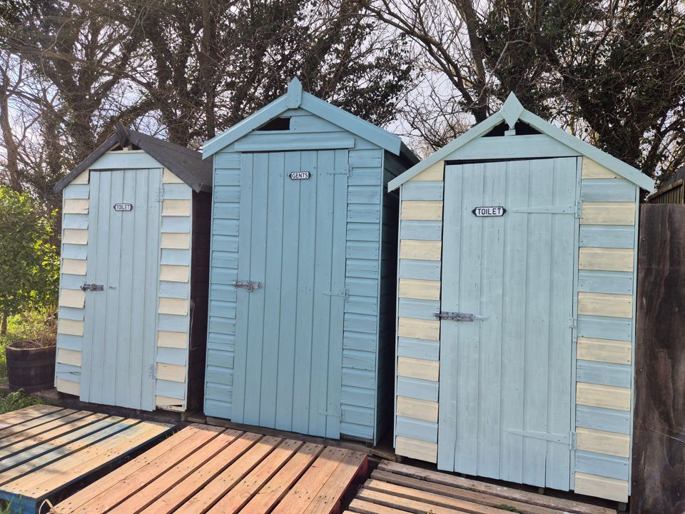 Beach huts by the trees