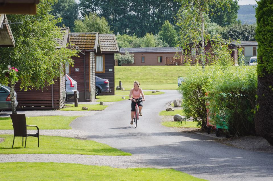 Cycling past timber lodges