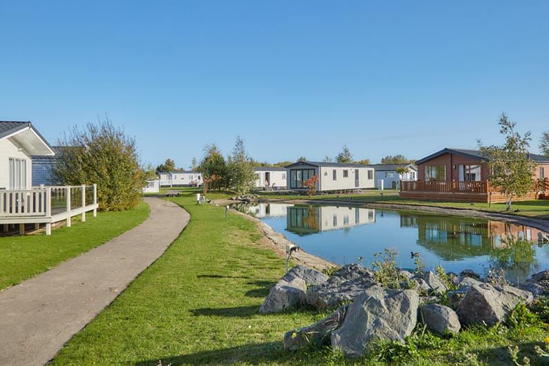 Caravans beside a pond
