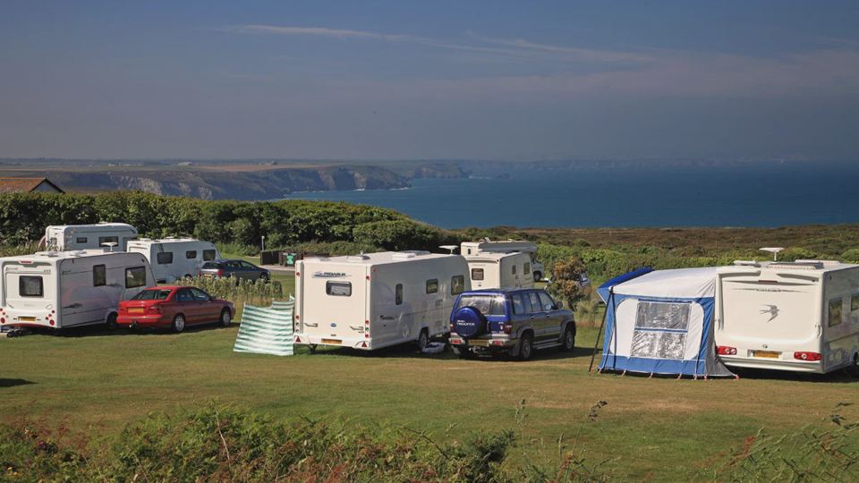 Caravans on grass by the coast