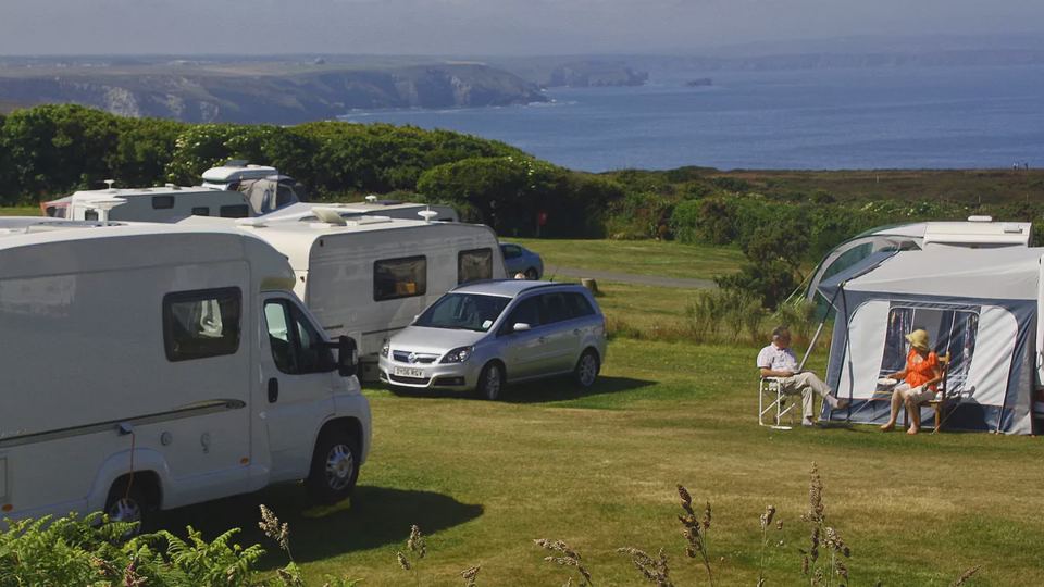 Motorhome and tent on grass pitch