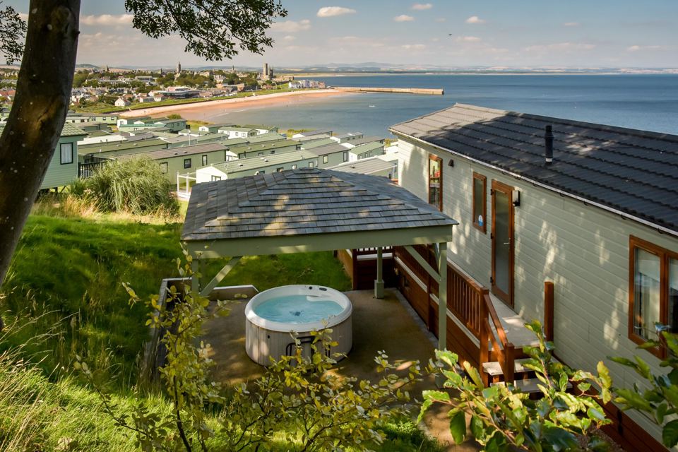 Caravan with hot tub above the bay