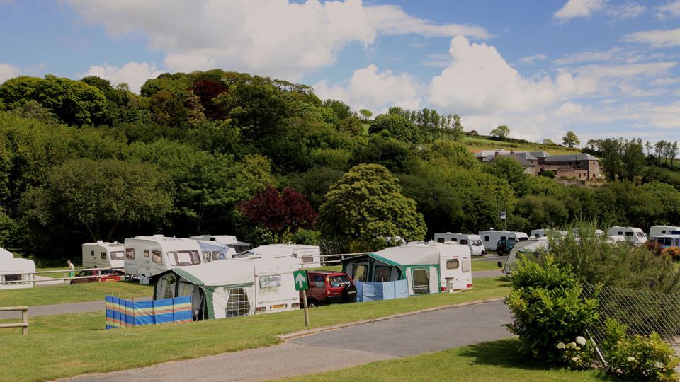 Caravans and tents under the trees