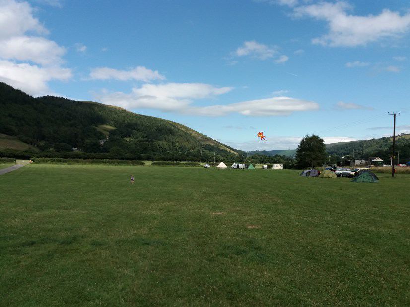Open tent field under the hills