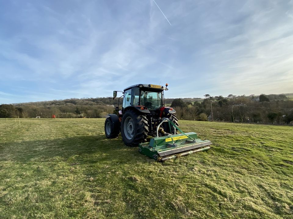Tractor mowing the camping field