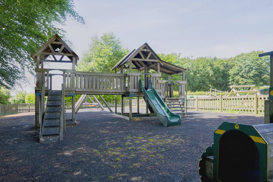 Wooden play structure with slide