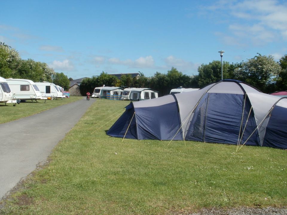Tent and caravans beside the road