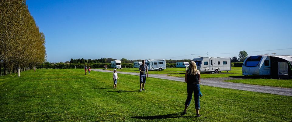 Grass pitches among the caravans