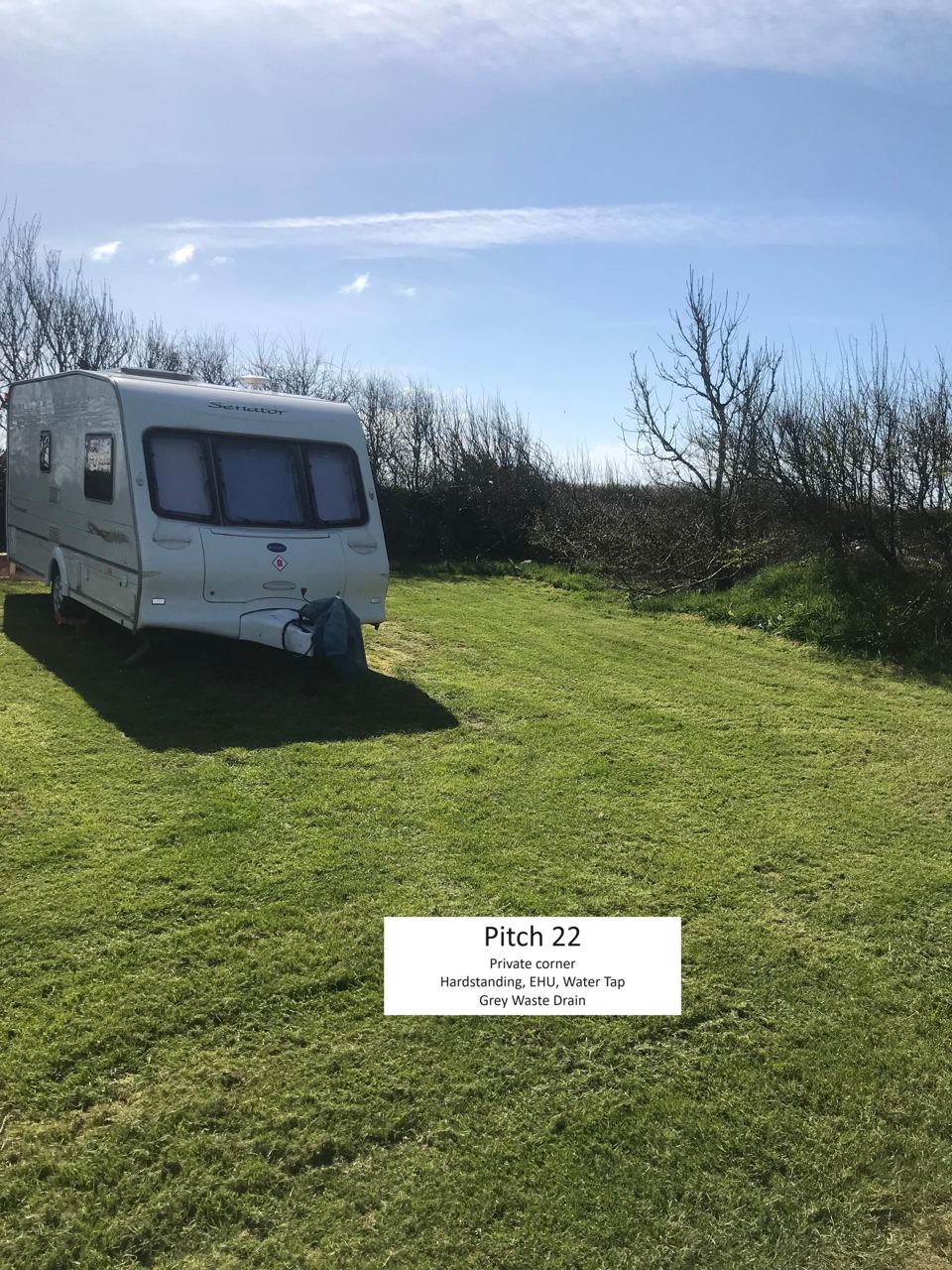 Caravan on numbered grass pitch