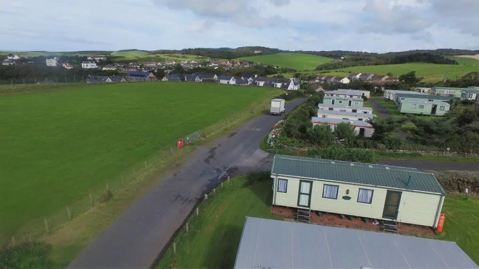 Open grass beside the homes