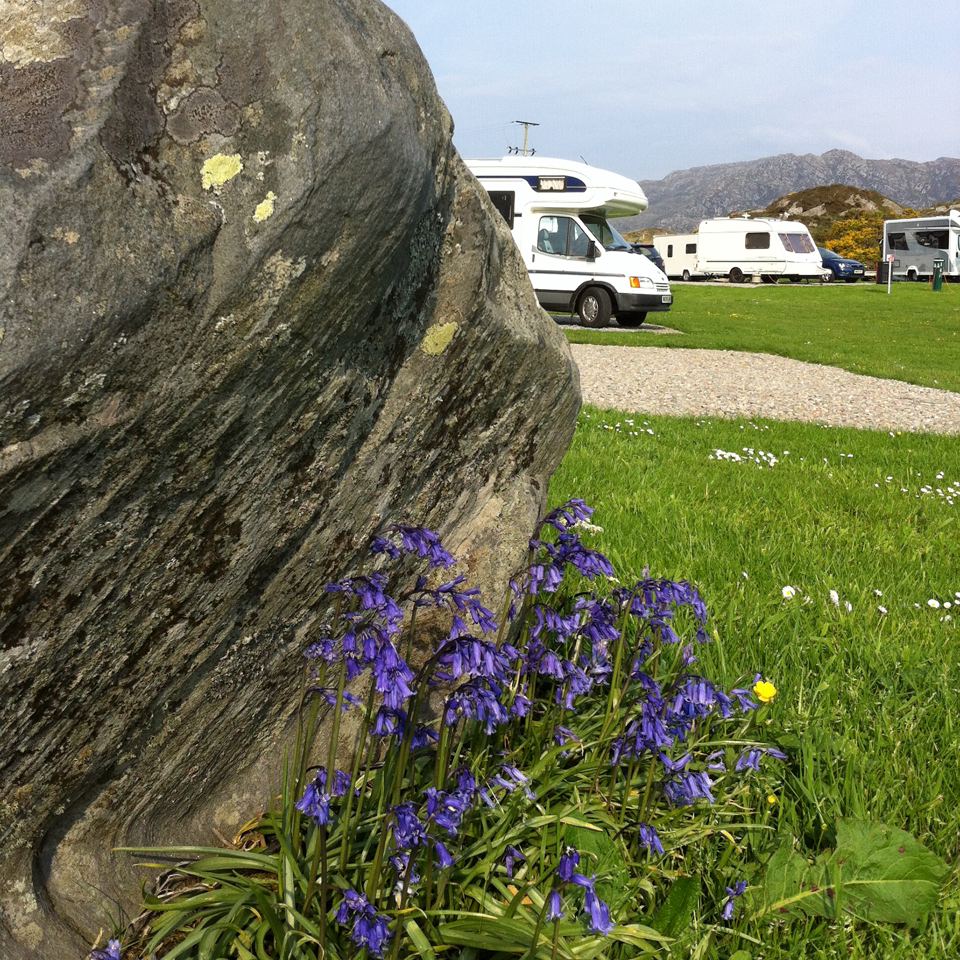 Motorhomes beyond a rock