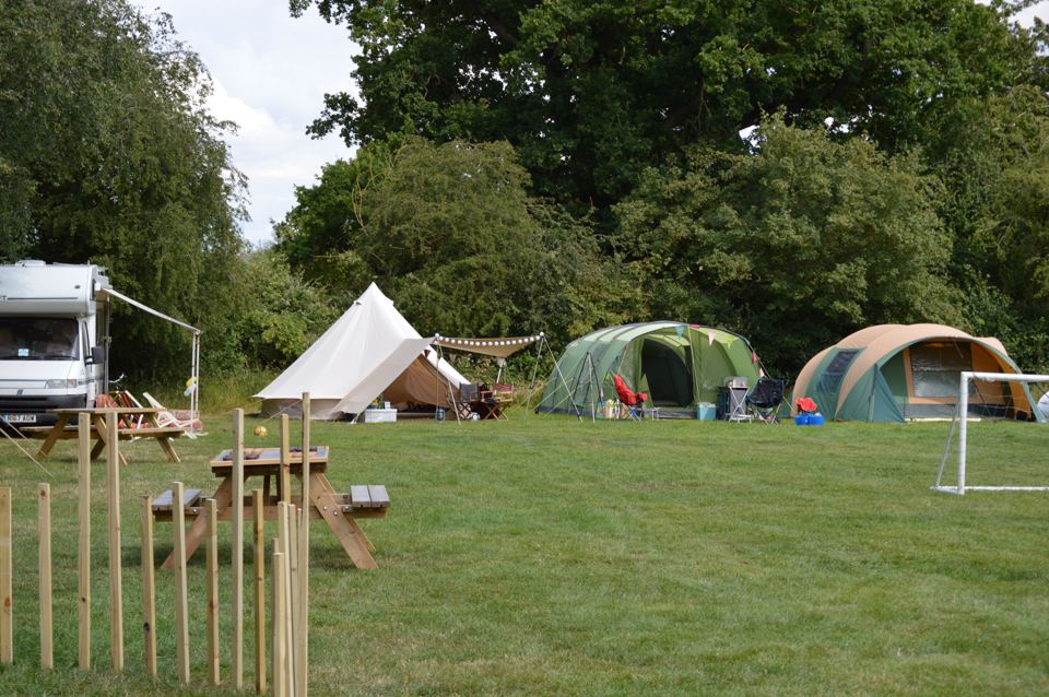 Tents and a motorhome in the field
