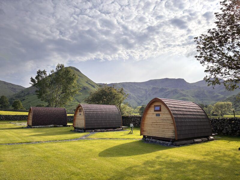 Pods on the grass with fells behind