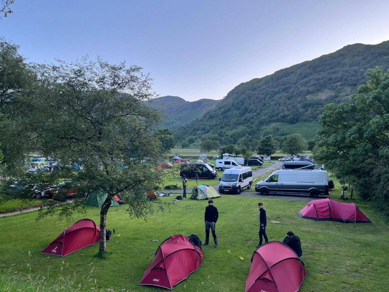 Tents in the field with fells beyond