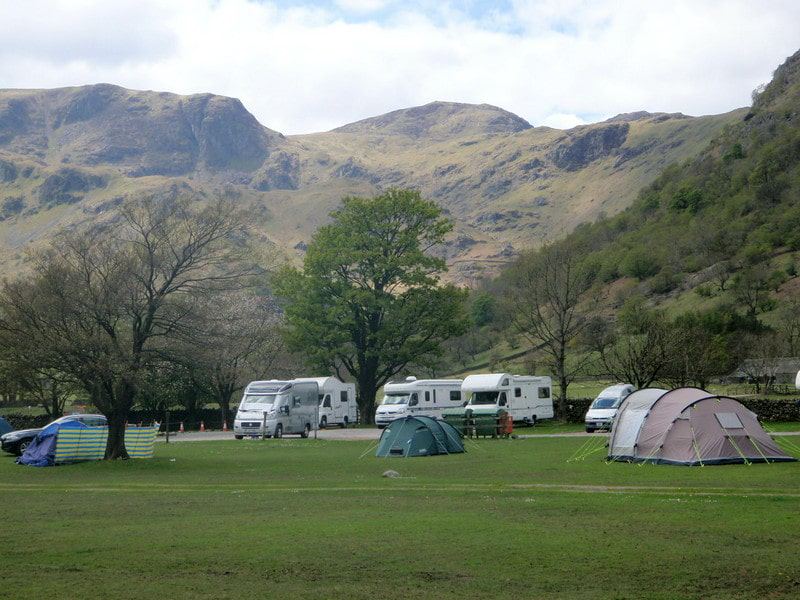 Tents and motorhomes below the fells
