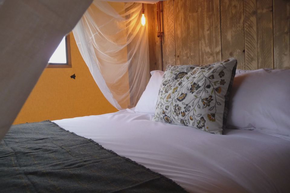 Bed inside a safari lodge