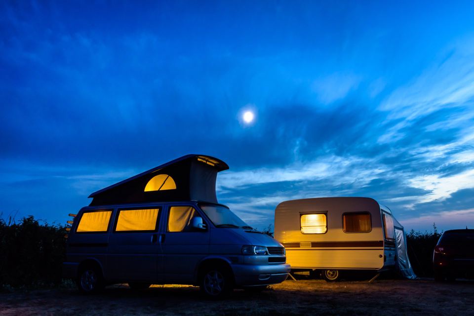 Campervan and caravan at dusk