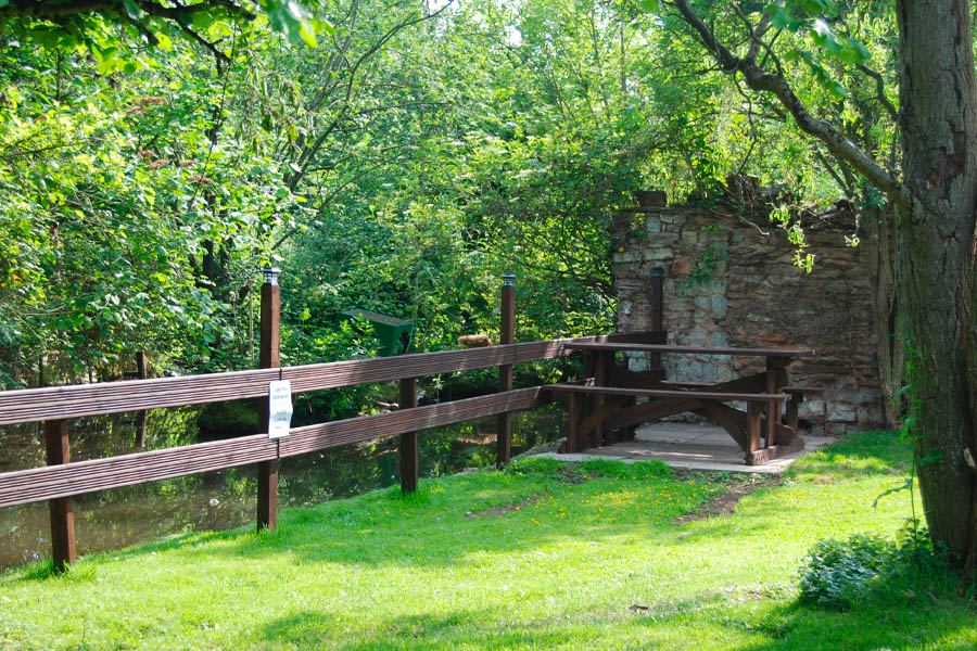 Picnic bench by the stream